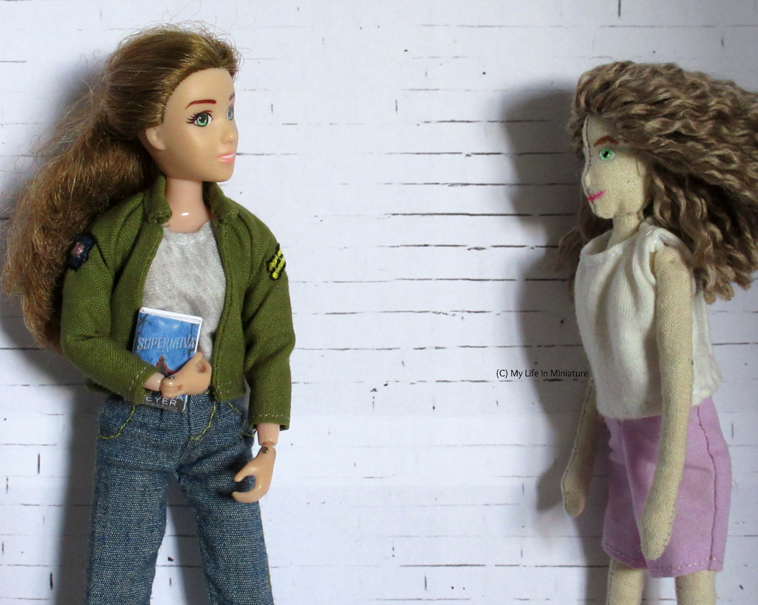 Sarah and the doll stand near each other. They are looking at each other. 