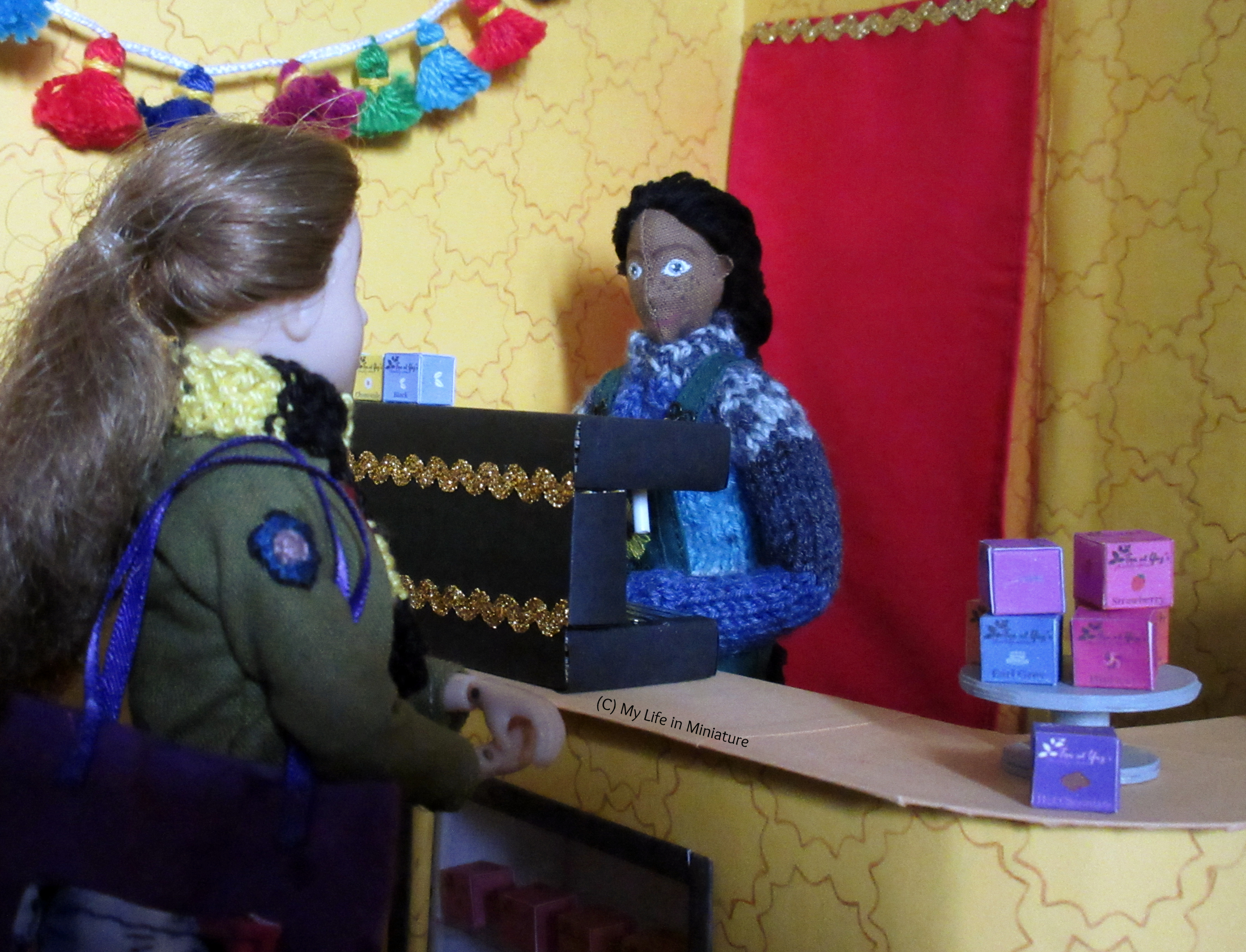 Sarah stands at the counter of Tea at Yaz's, looking at Petra. Petra's behind the coffee machine, making a drink. She looks back at Sarah.