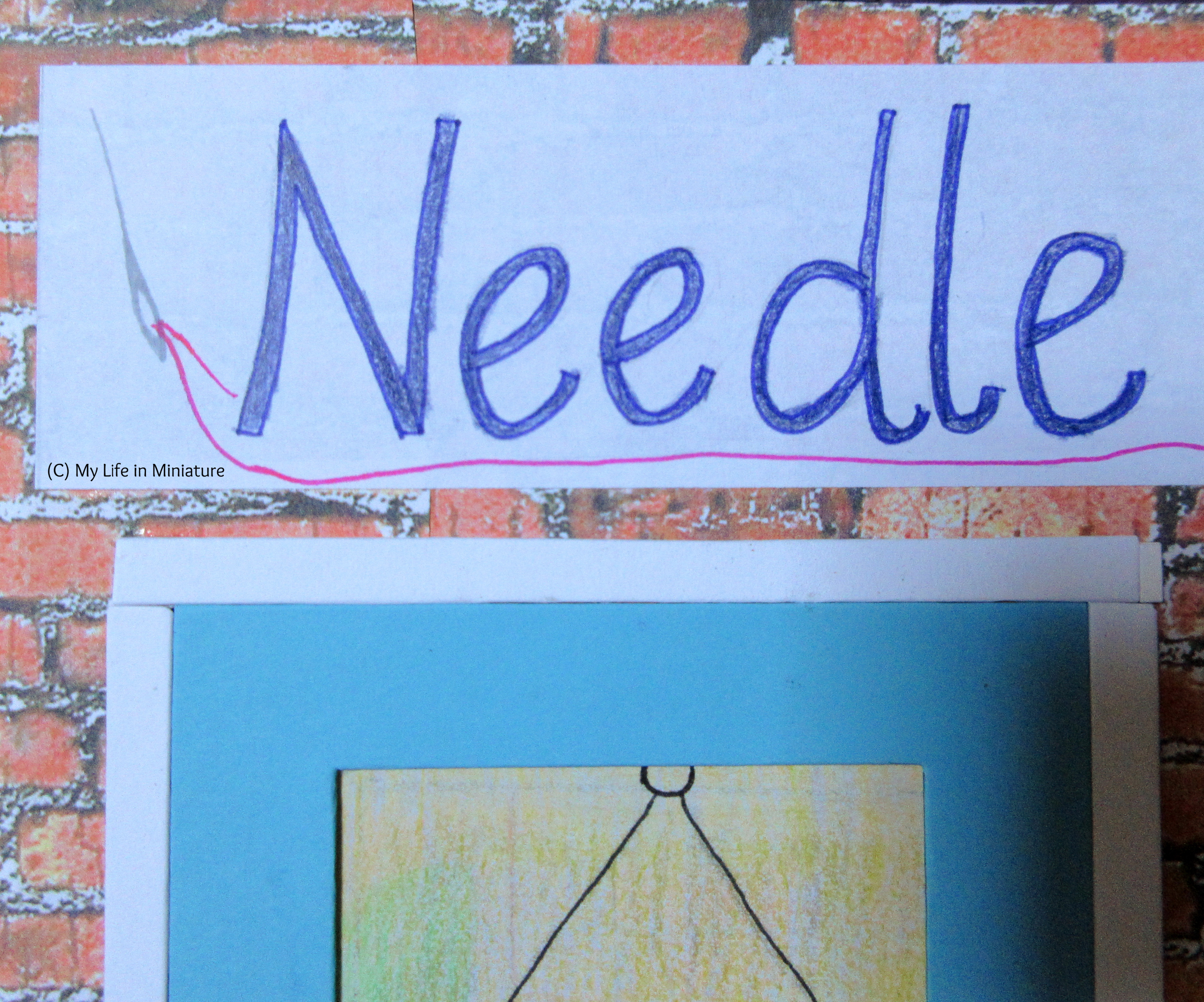Close-up of the 'Needle' part of Needle & Thread's sign. a silver needle is visible, threaded with neon pink thread. 
