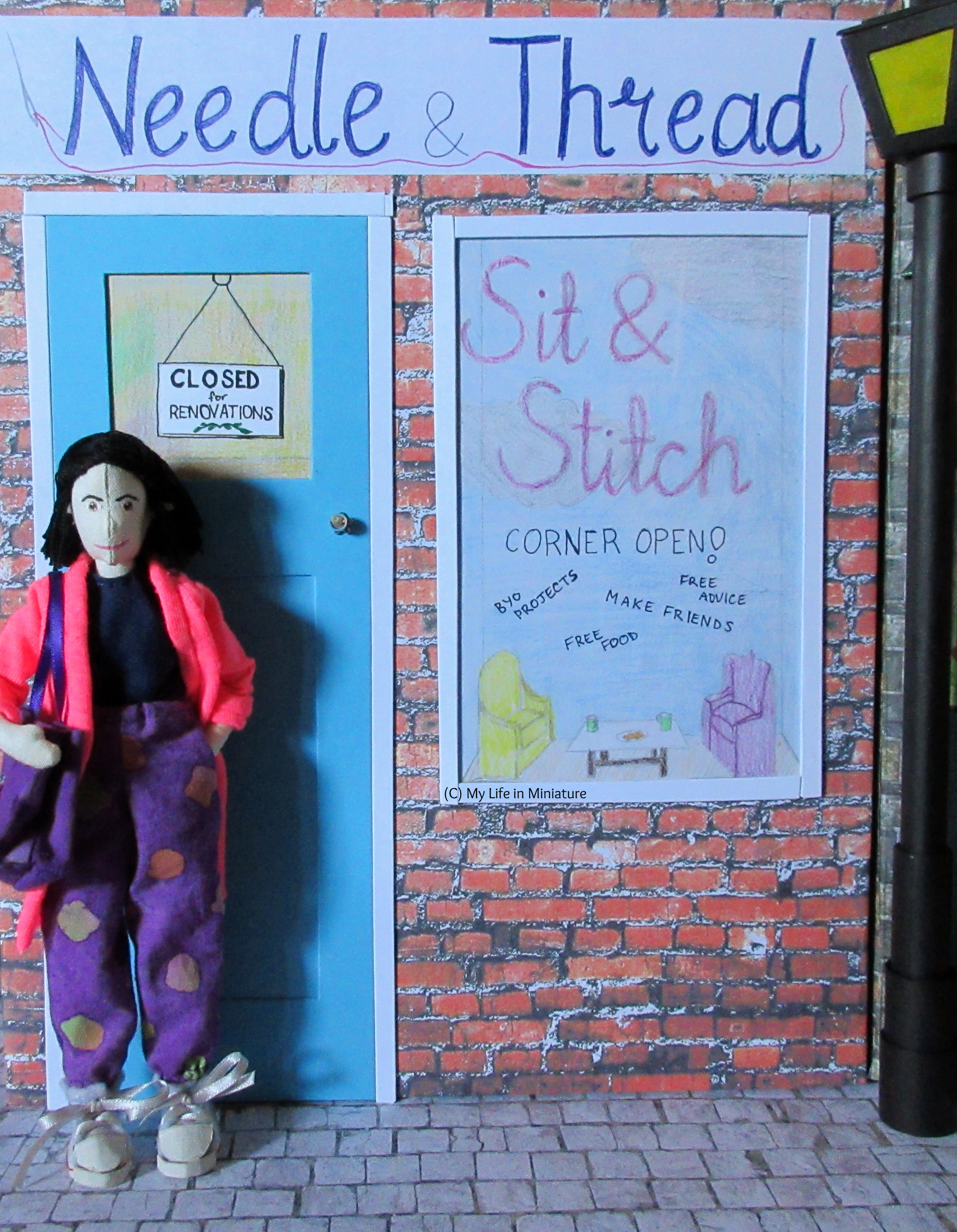 Tiffany stands in front of the blue door of Needle & Thread's front façade. She has a purple tote bag on her shoulder, and a hand in her pocket.