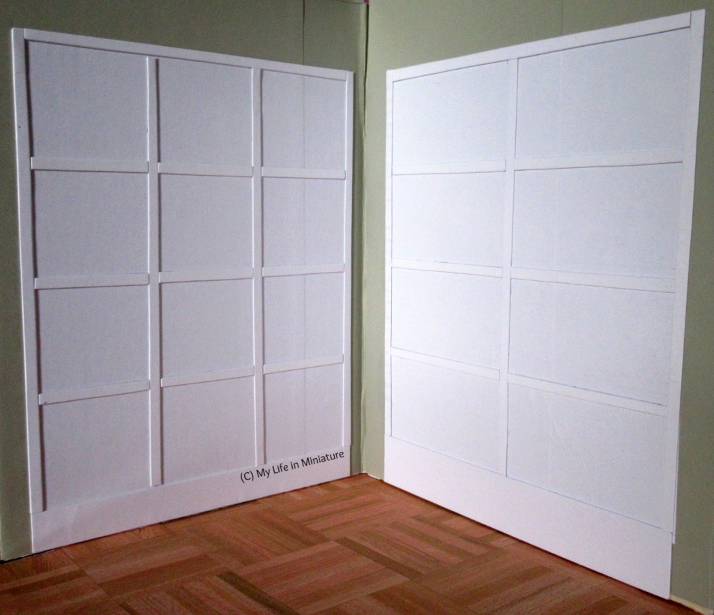 Interior of Needle & Thread. Camera looks into the corner, and on the two walls are two white 'cabinets', that are flat on the walls.
