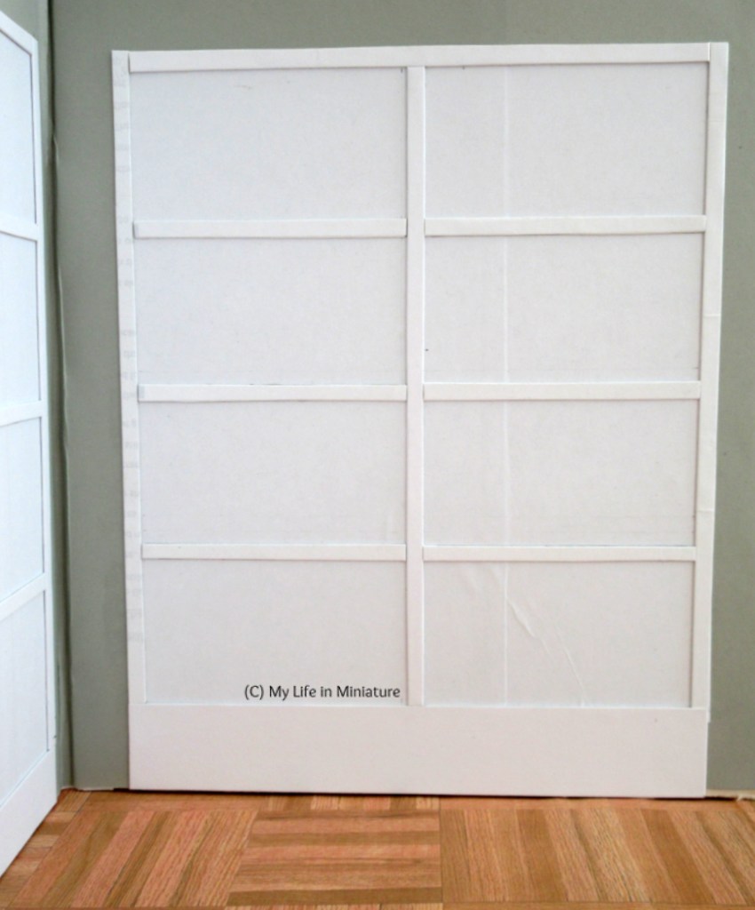 Image shows the right-hand cabinet from the previous image. It is white and has eight rectangular shelves.