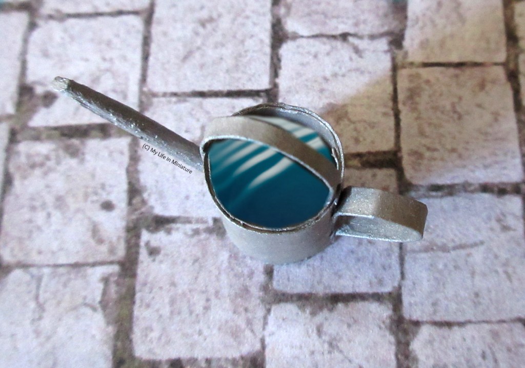 Overhead view of the inside of the can, which has 'water' edited in, so the can looks like it's full of water.