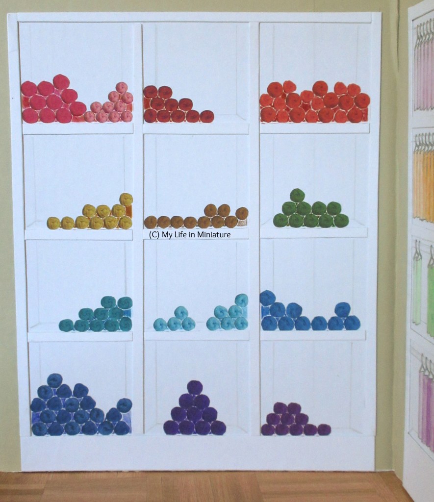 Full view of Needle & Thread's yarn shelves. Yarn is arranged in rainbow order from top left to bottom right on the shelves. 