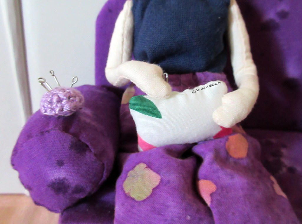 Close-up of Tiffany stitching the opening of a rectangular cushion closed. 