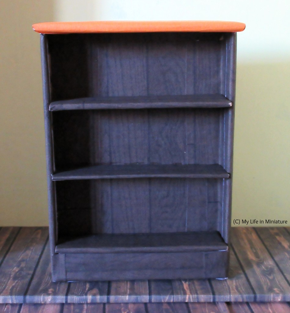 Back view of the counter. Three shelves are visible, as well as the bright orange counter. 