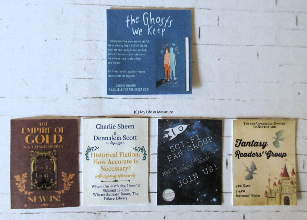 The five different flyers sit flat on a white brick background. They are arranged in a row of four at the bottom, and one at the top centre. The top centre one advertises a book called 'The Ghosts We Keep'. The bottom row advertises, left-right; a book called 'The Empire of Gold', two authors in discussion about 'Historical Fiction: How Accurate is Necessary?', a sci-fi fan group, and a fantasy readers' group.