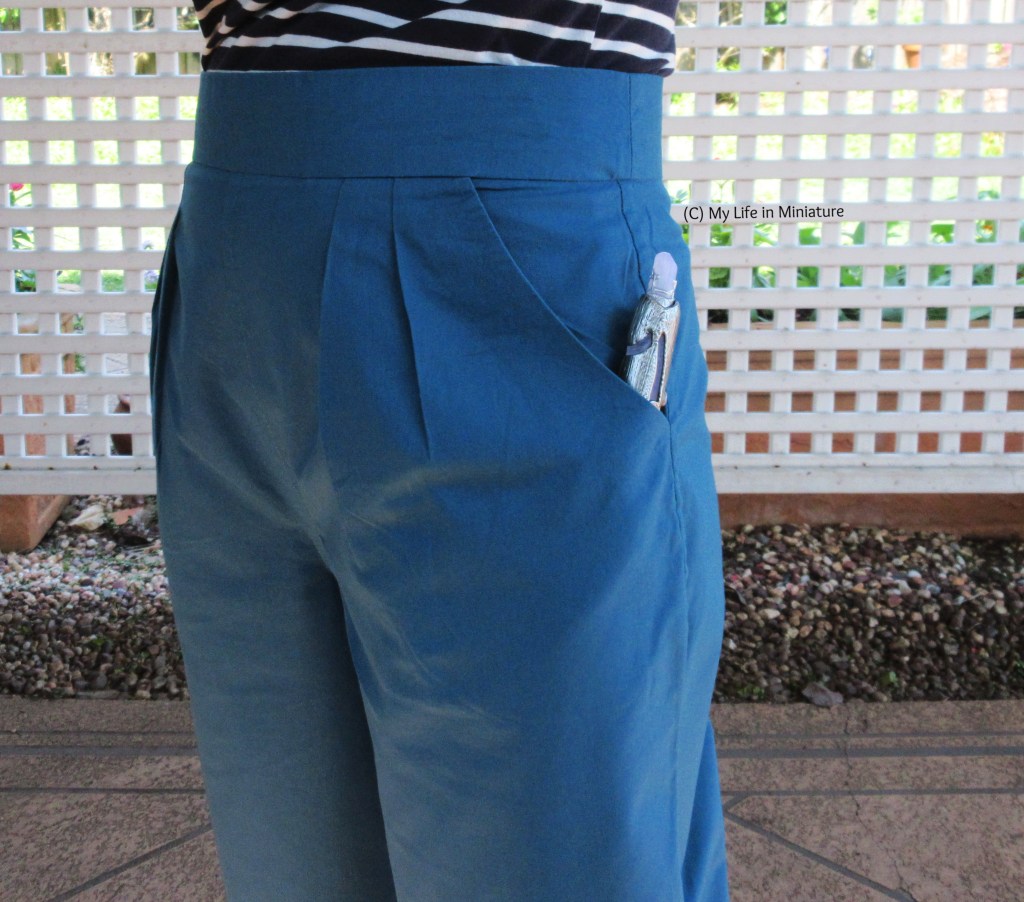 Another close-up of the pants, this time the left side. In the pocket is a replica of the 13th Doctor's screwdriver, the tip poking out.