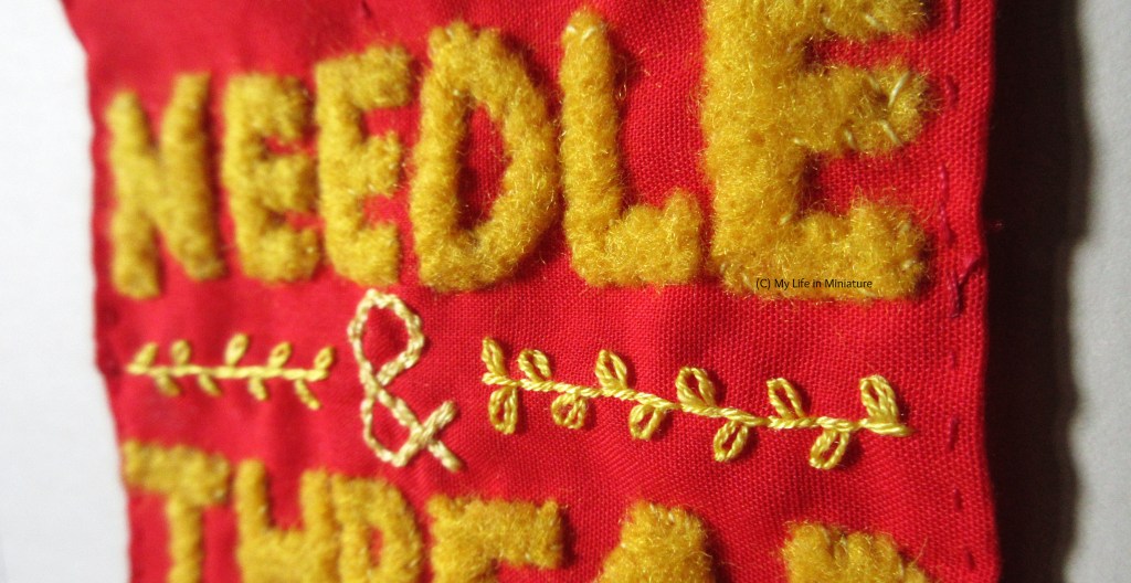 Super-close close-up of the banner, showing the embroidery and the appliqué in more detail.