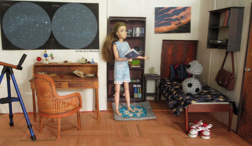 Wide-angle shot of Sarah in her room, standing on her carpet holding an open notebook. Chip is on her bed, to Sarah's right, head elevated and looking at her. She wears her pale blue playsuit with white lace along the leg hems.