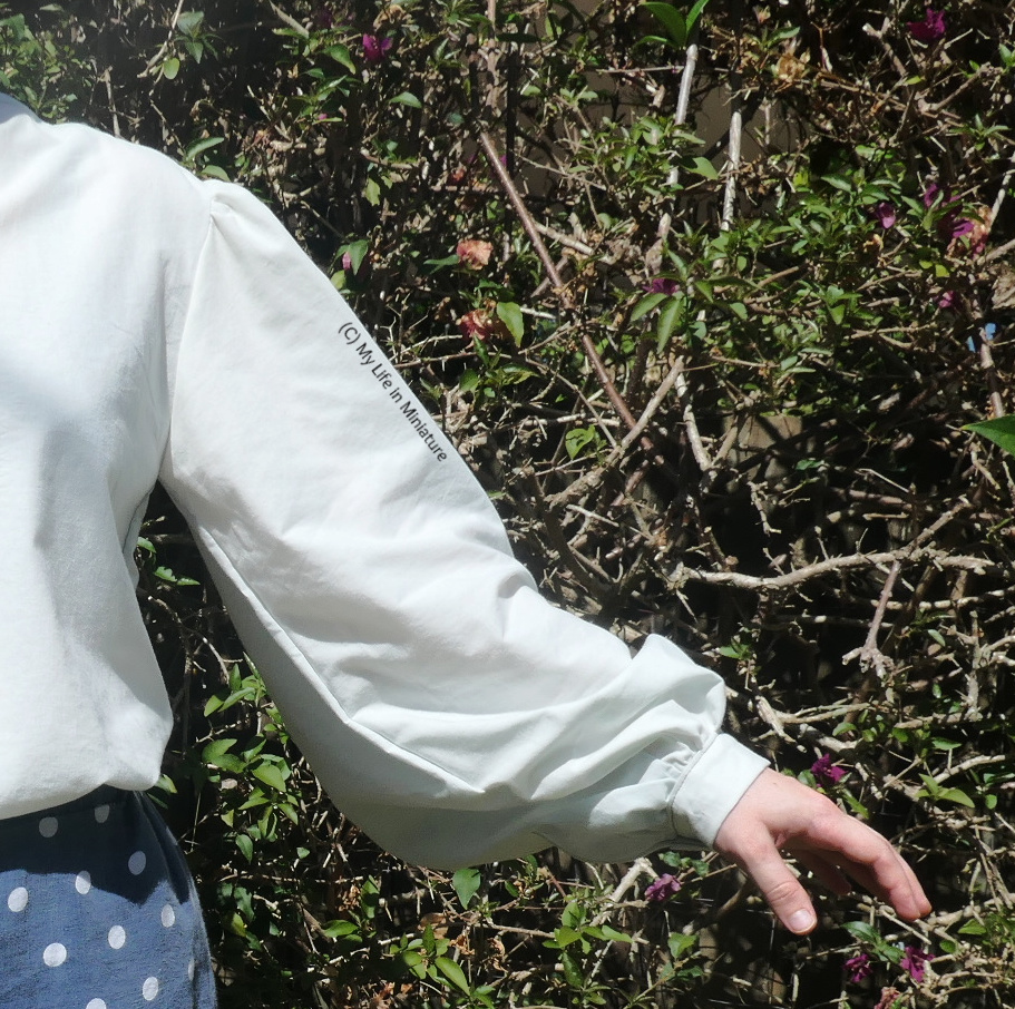 Close-up of the second sleeve, which is the poofy pirate-shirt-esque one. The sleeve is gathered at the shoulder and the wrist, with a smaller cuff at the wrist. It is very voluminous.