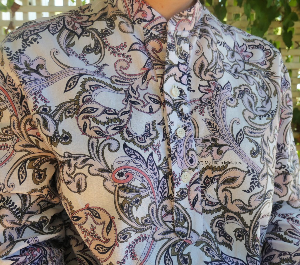 Close-up of the centre front button placket of the author's shirt. The buttons are creamy-white, and the placket ends at a point at about mid-torso. 