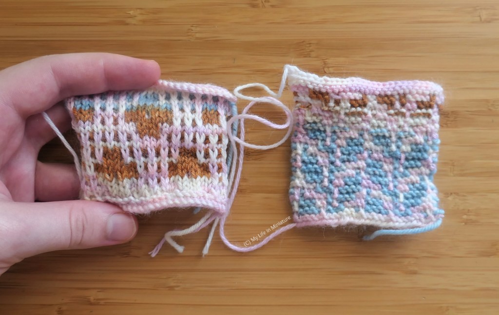 Close-up of the two knitted swatches. The left-hand one is being held flat by the author, and has a geometric floral pattern knitted in smooth stocking stitch. The right-hand one is knitted in bumpy garter stitch, and has a pattern of two stem-and-leaf shapes, side-by-side. They are both knitted in two different colour-changing yarns.